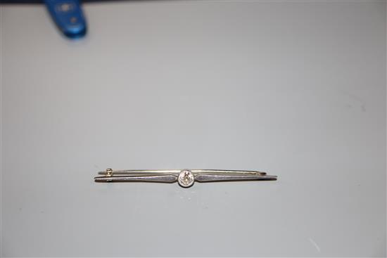 A white metal and solitaire diamond set bar brooch, 56mm, gross 3.3 grams.